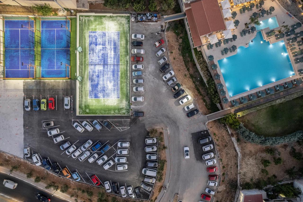 Porto Platanias Beach Resort & Spa Exterior foto Aerial view of the tennis courts